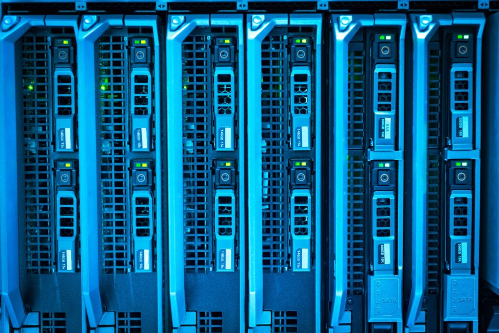 Choosing Managed IT Services As Your Company Expands 3 Detailed image of illuminated server racks showcasing modern technology infrastructure.