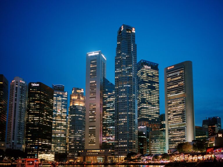 Stunning view of Singapore's financial district skyline at night with illuminated skyscrapers.