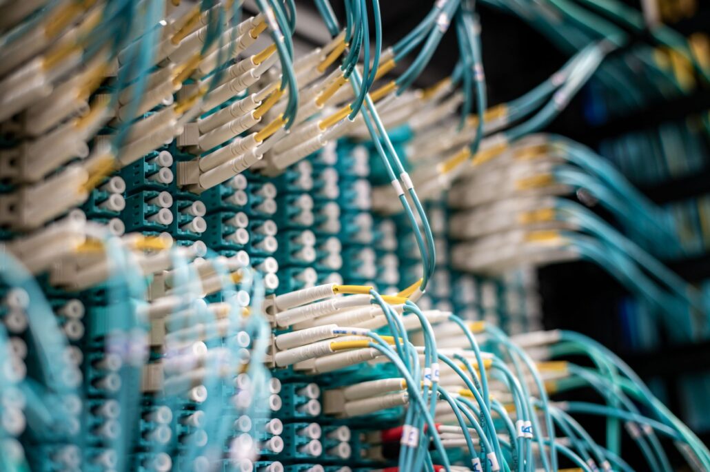Managed IT: Building Technology That Scales With You 1 From below of fiber optic switch with sockets and connected rubber cables on blurred background