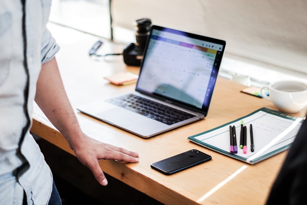 How Quality Methods Make Workflows Consistent at Scale 1 Person checking a printed process checklist next to a laptop on a desk